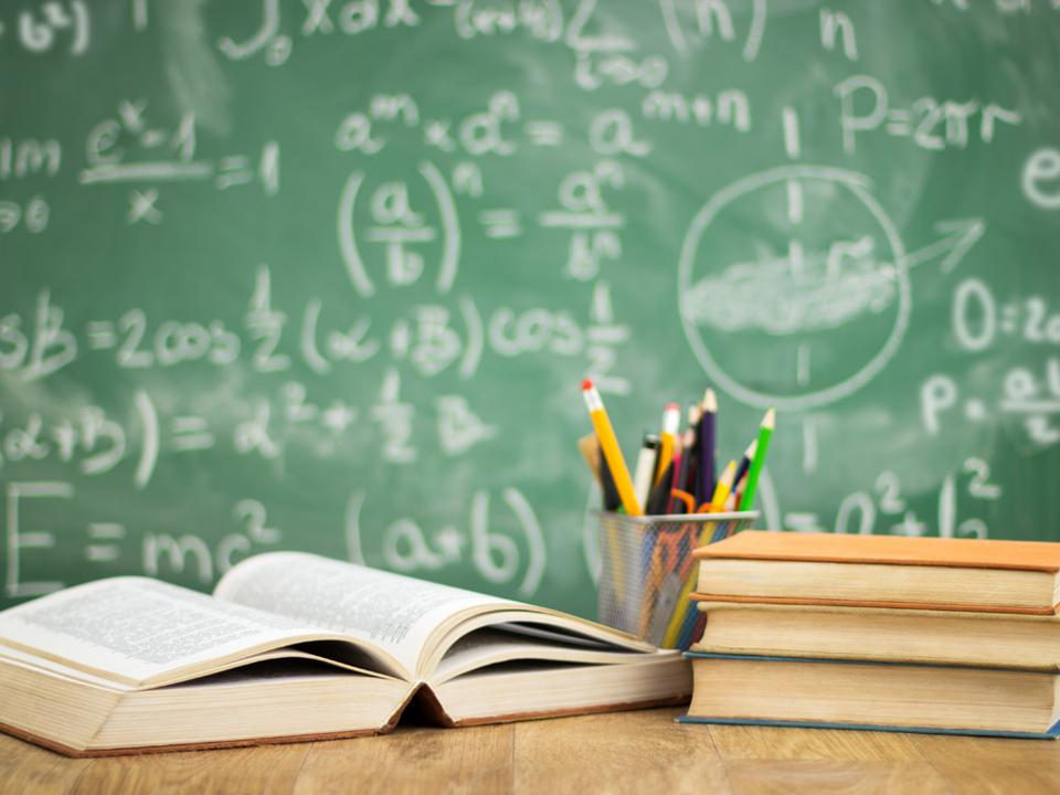 school books and chalk board