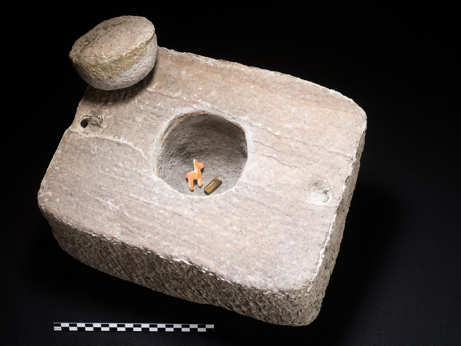 stone box with llama and gold scroll in hole