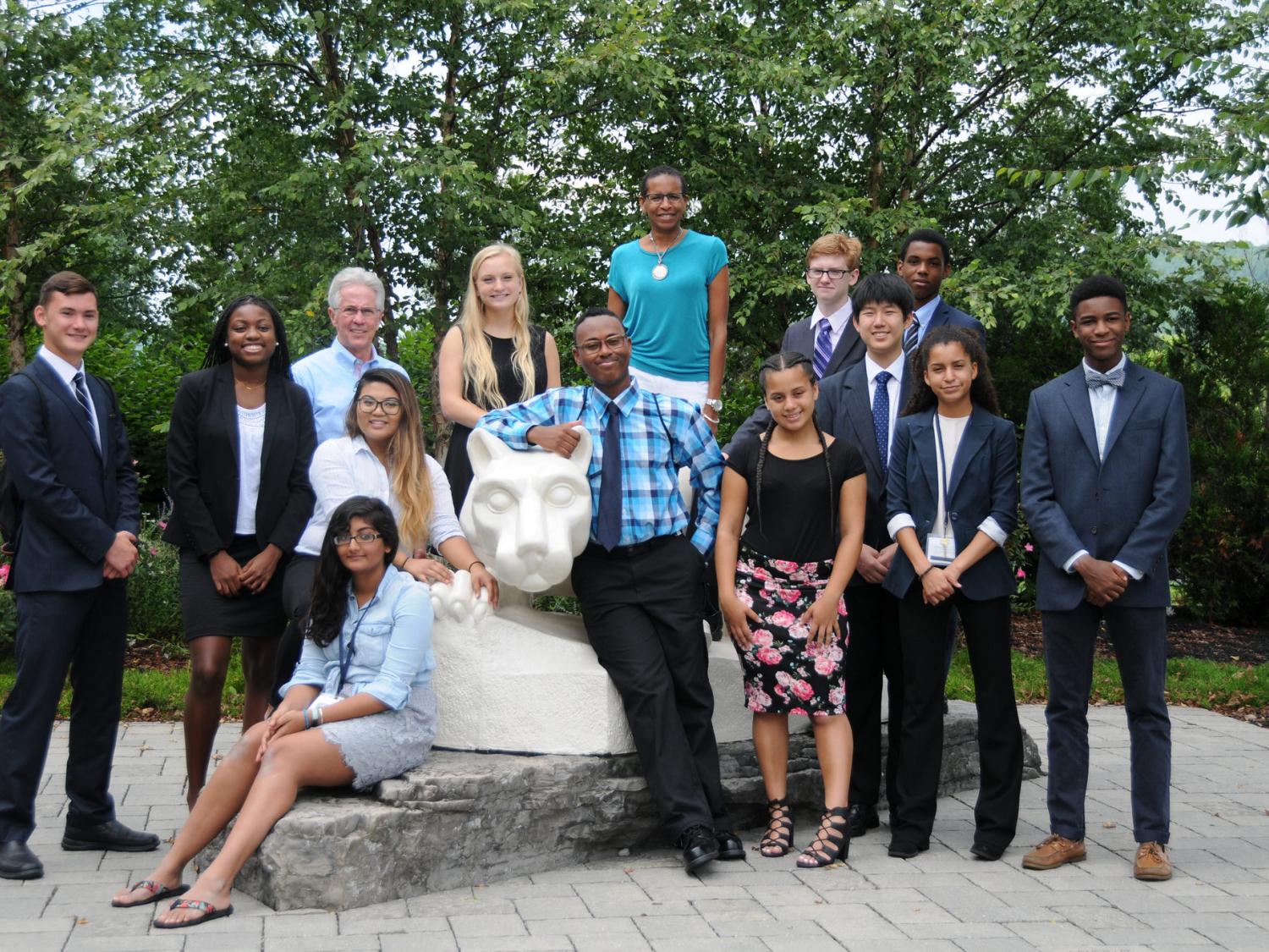 group pose around lion shrine