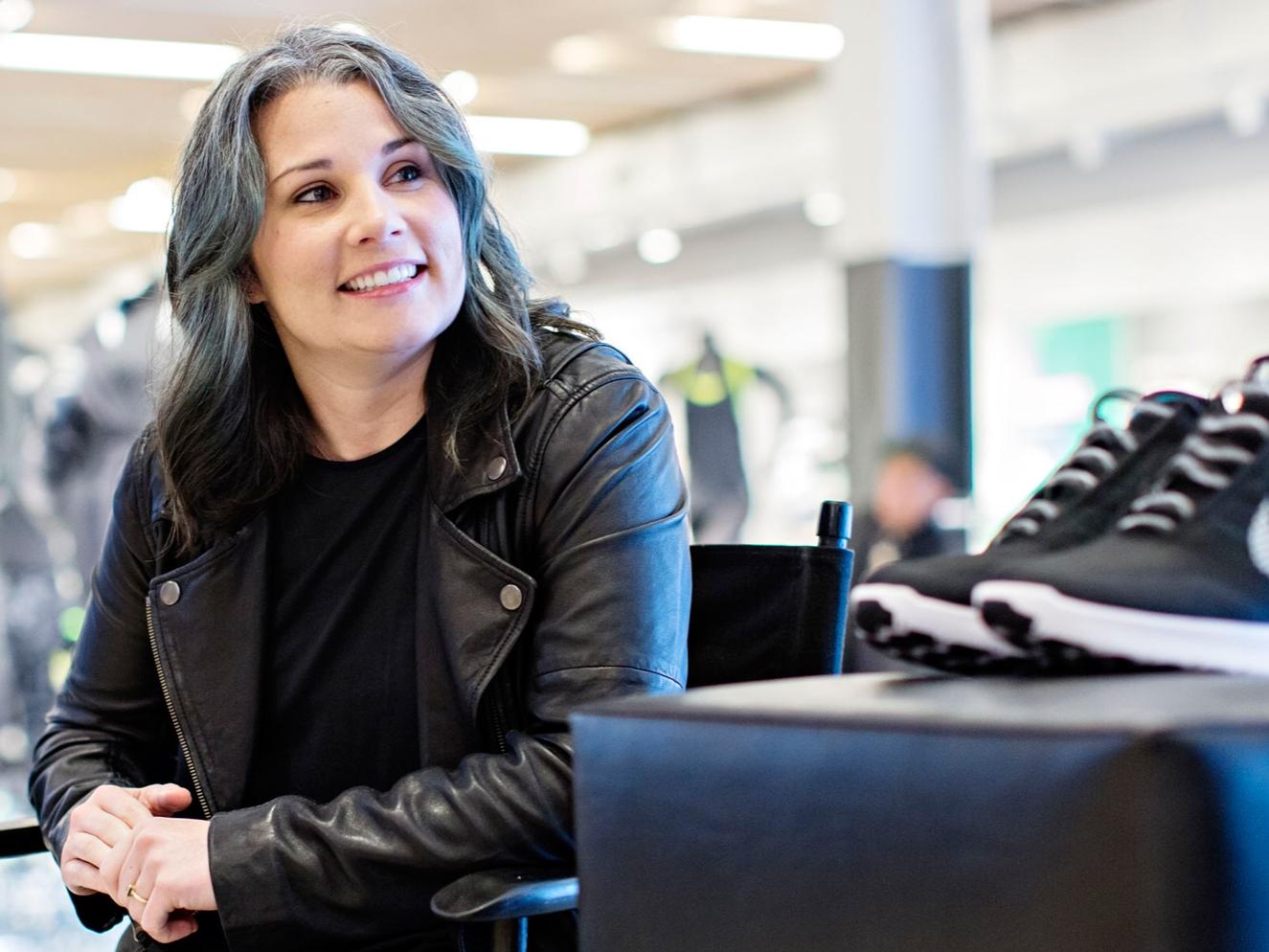 Tiffany Beers, a senior innovator at Nike, poses with the company's HyperAdapt 1.0 shoes.