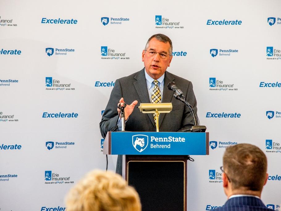 Erie Insurance Group President and CEO Tim NeCastro speaks at a podium during an announcement program for a new partnership with Penn State Behrend.