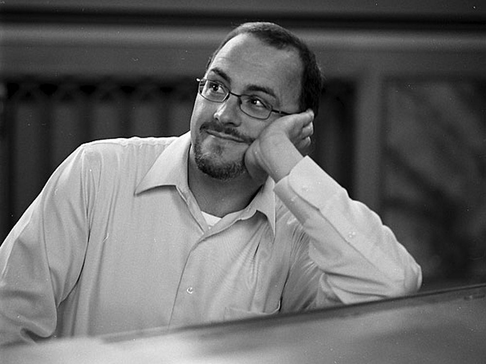 Tom Roberts sitting at piano