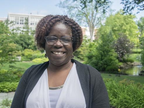 Woman standing with campus in background