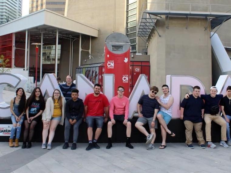 A group of Penn State Behrend students pose outside the CN Tower in Toronto.