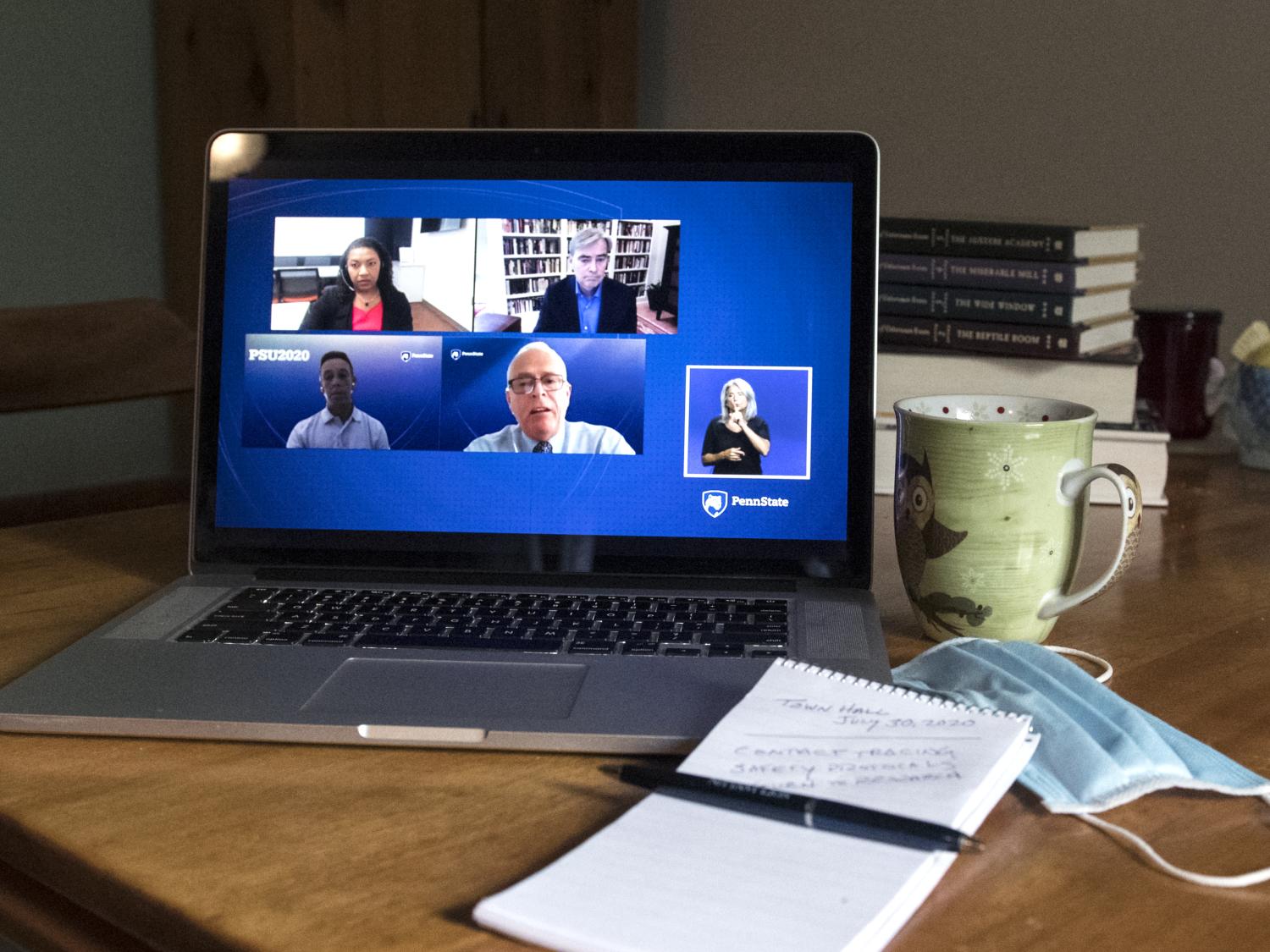 Image of virtual town hall from laptop on table