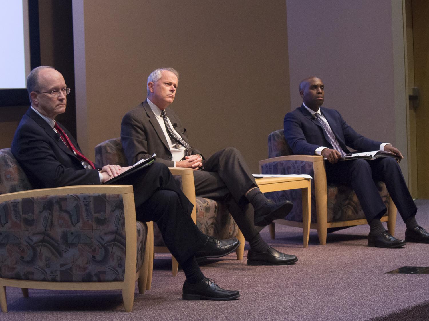 Three panelists on stage