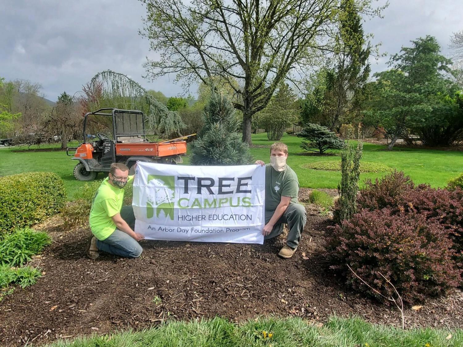 Penn College students hold a Tree Campus banner