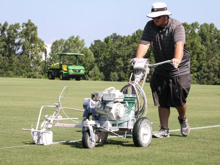 Turf Science grad Collin Meyers lines field