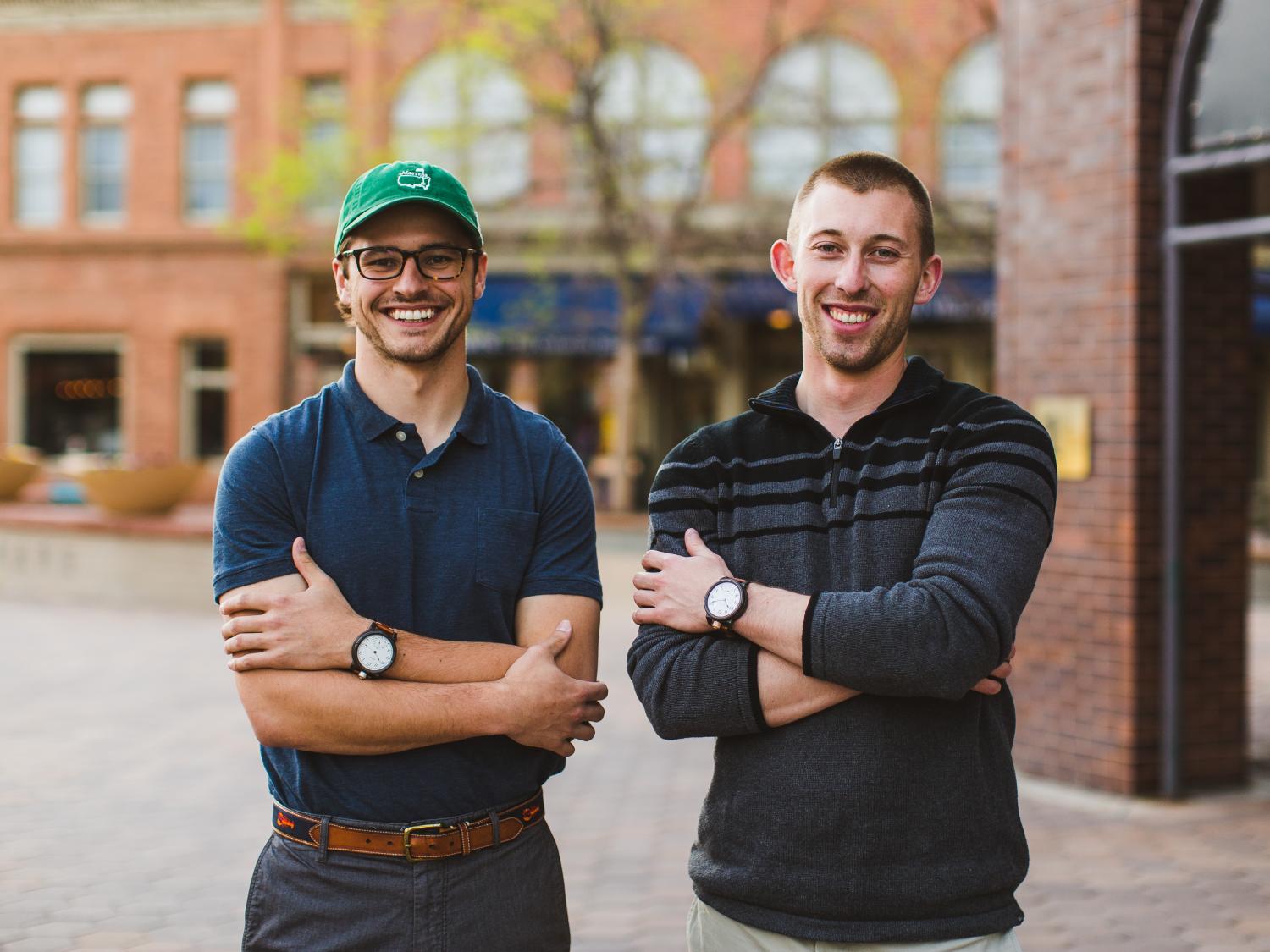 Vortic co-founders Tyler and R.T. standing in downtown Fort Collins wearing Vortic watches.