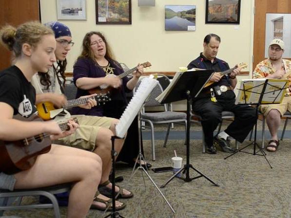 Members of the Allegheny Ukulele Kollective practice during an open jam session.