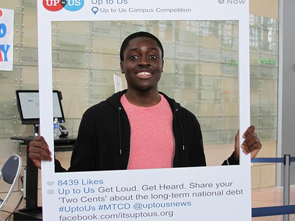 A student poses with a faux Instagram frame on My Two Cents Day.