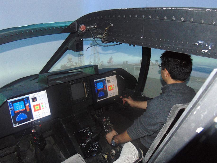 Ilker Oruc, doctoral candidate in aerospace engineering, approaches a frigate in an SH-60 helicopter in the VLRCOE Fixed-base Flight Simulator Lab.