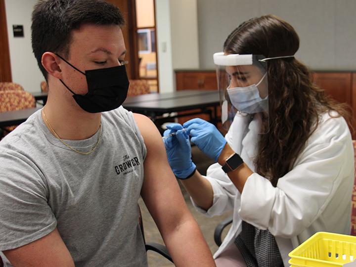 Student participate in vaccination clinic held on campus.