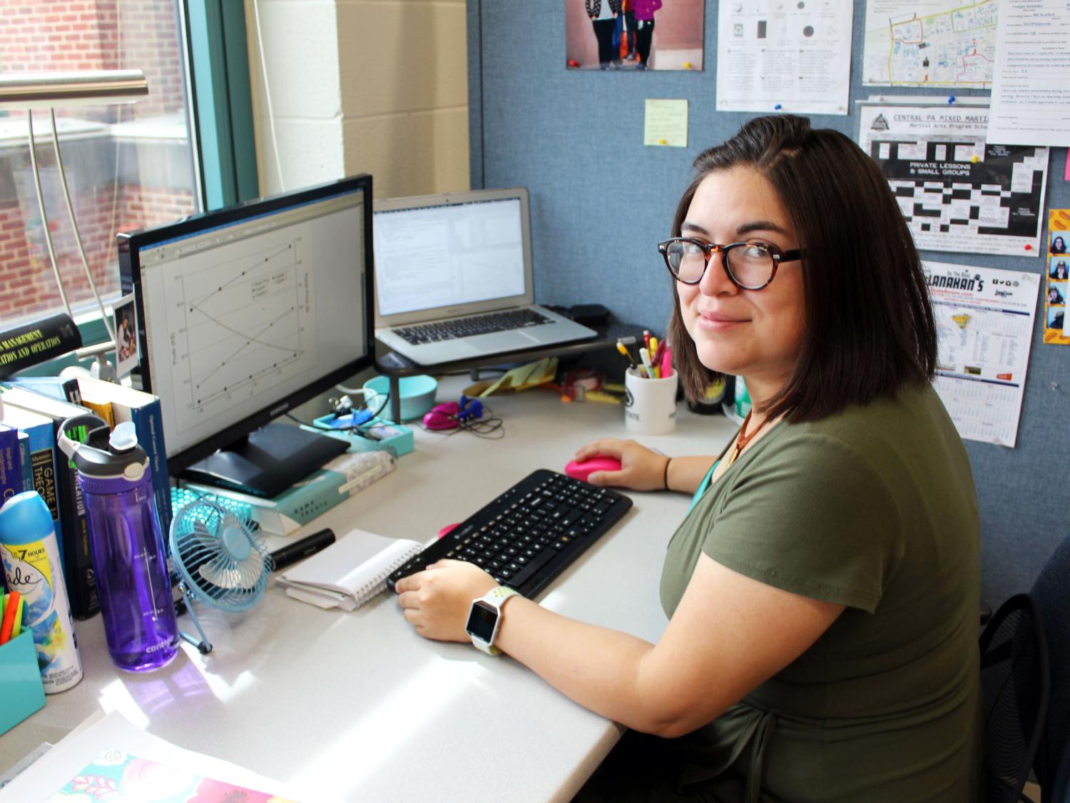 Barbara Venegas sits at her desk in the optimization lab