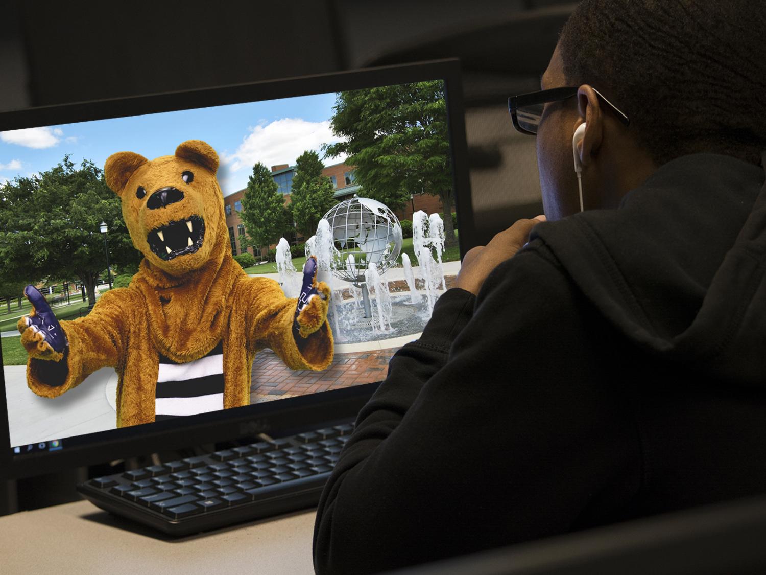 student looking at Nittany Lion on computer screen