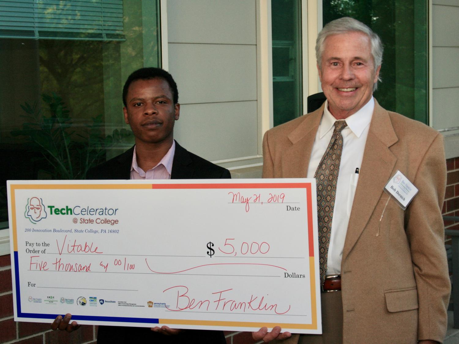 Joseph Kitonga receives TechCelerator prize from Bob Dornich