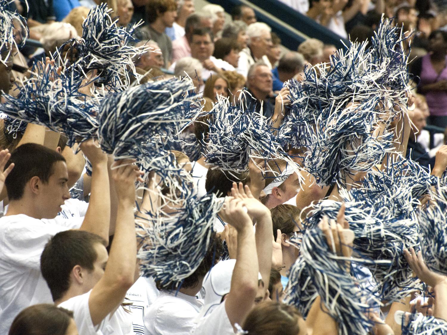 Penn State fans wave blue and white pom-poms.