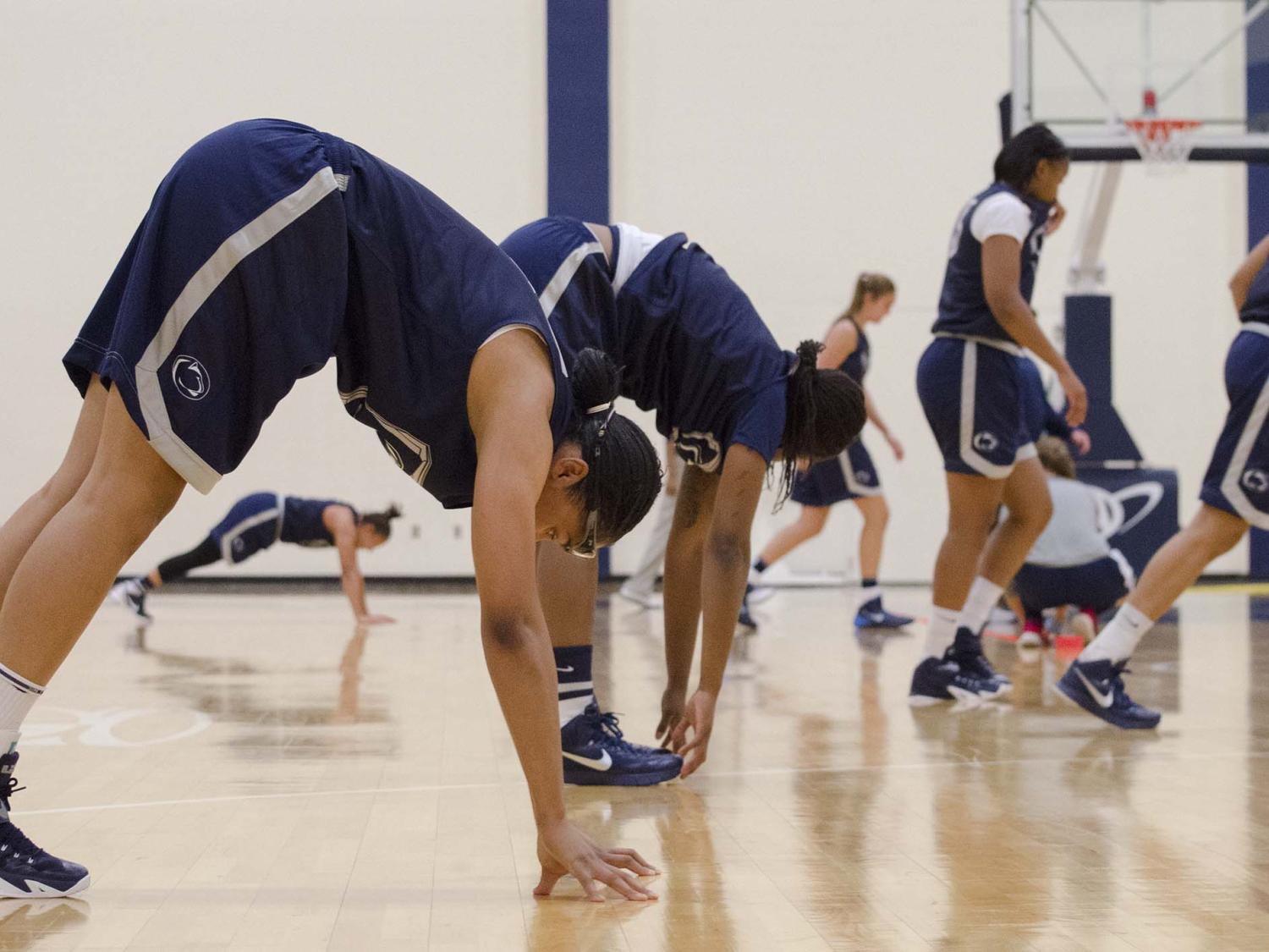 Women basketball players stretching 
