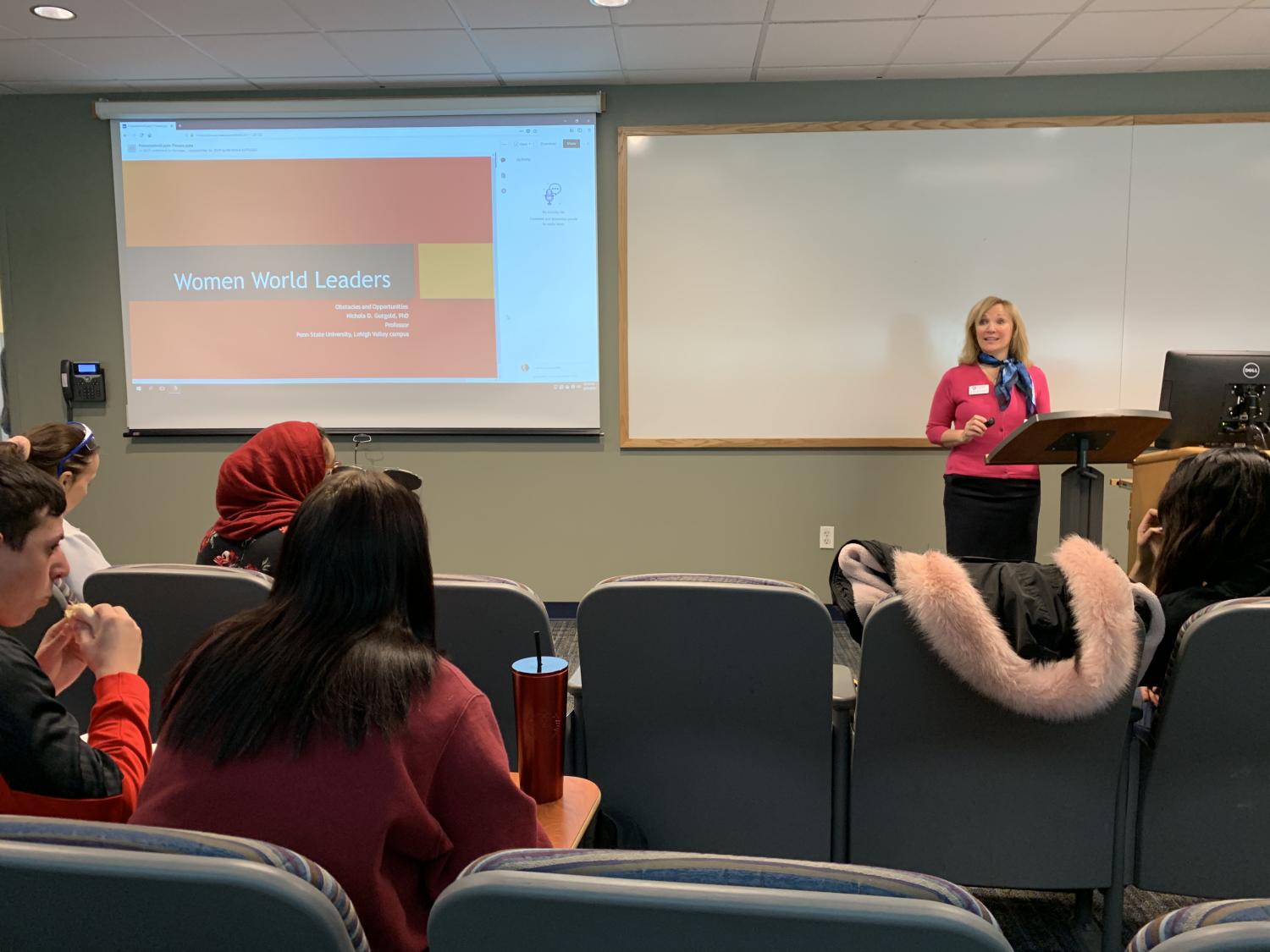 woman lecturing a group