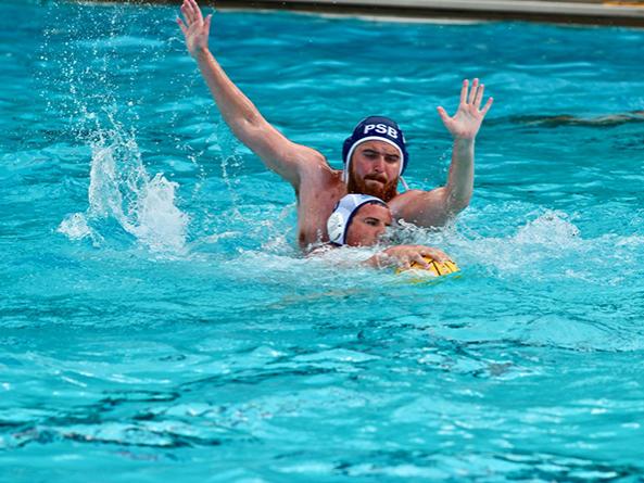 A Penn State Behrend water polo player battles for the ball.