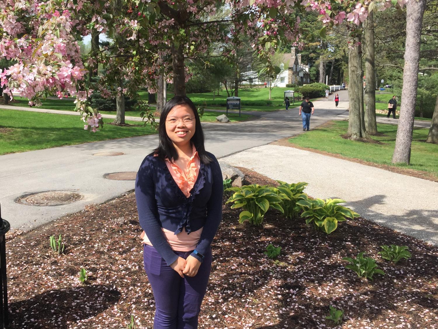 Wenrui Cai pictured outside, in front of a tree.