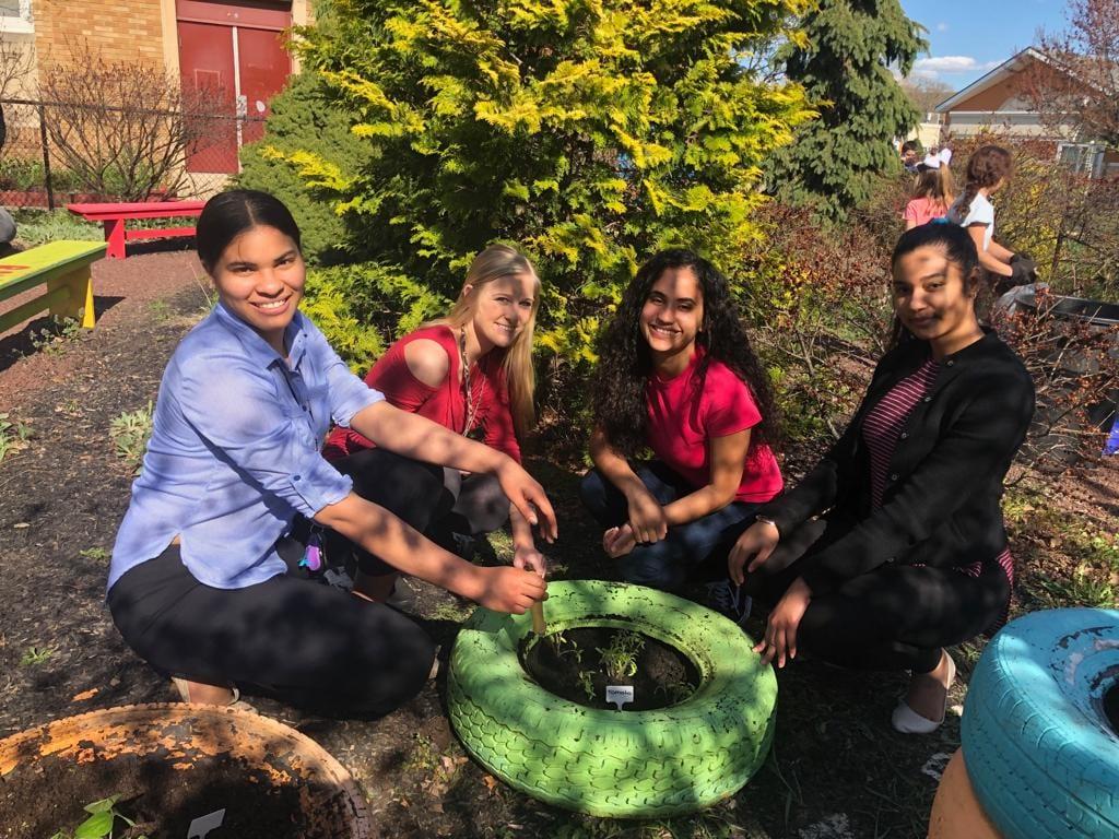 Penn State students help plant with the gardening club at Glenside Elementary