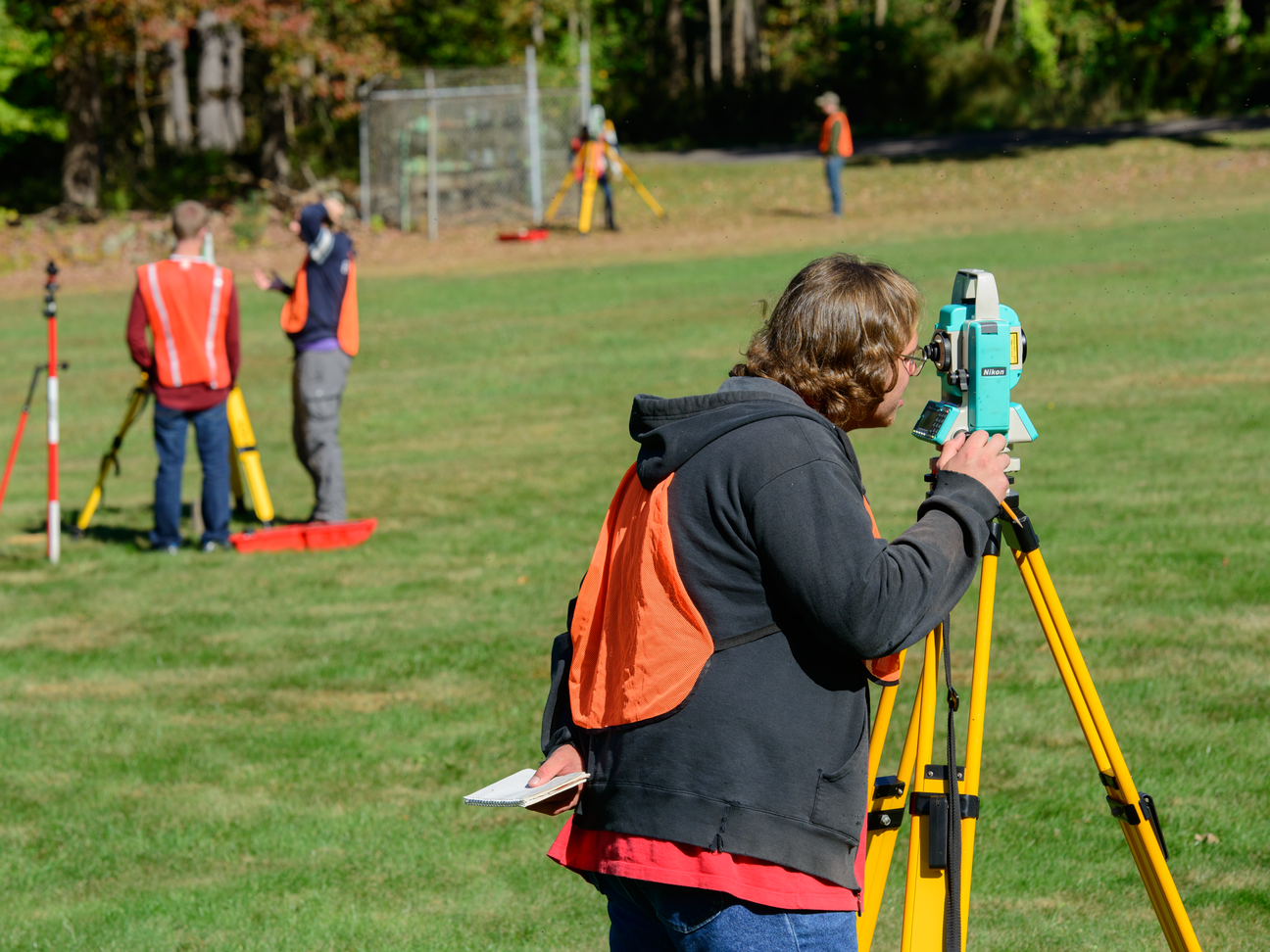 Students using surveying equipment