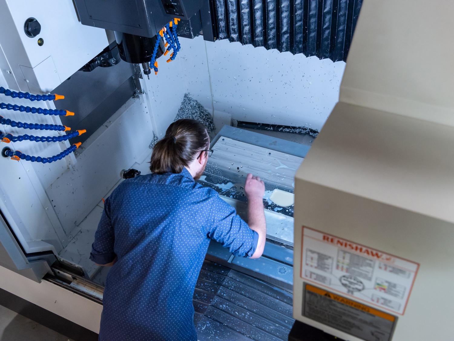 Jaron Williams works on his senior project, for which he made use of a vertical machining center on loan to Penn College.