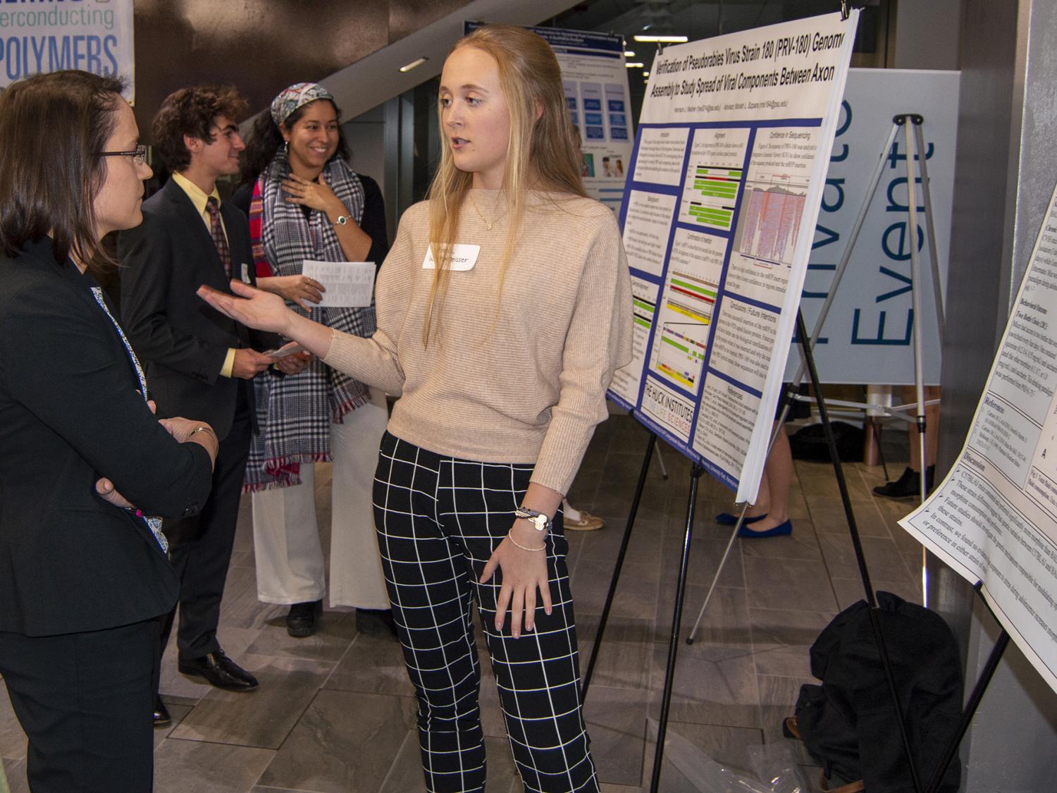 Allison Beese talks with a symposium presenter