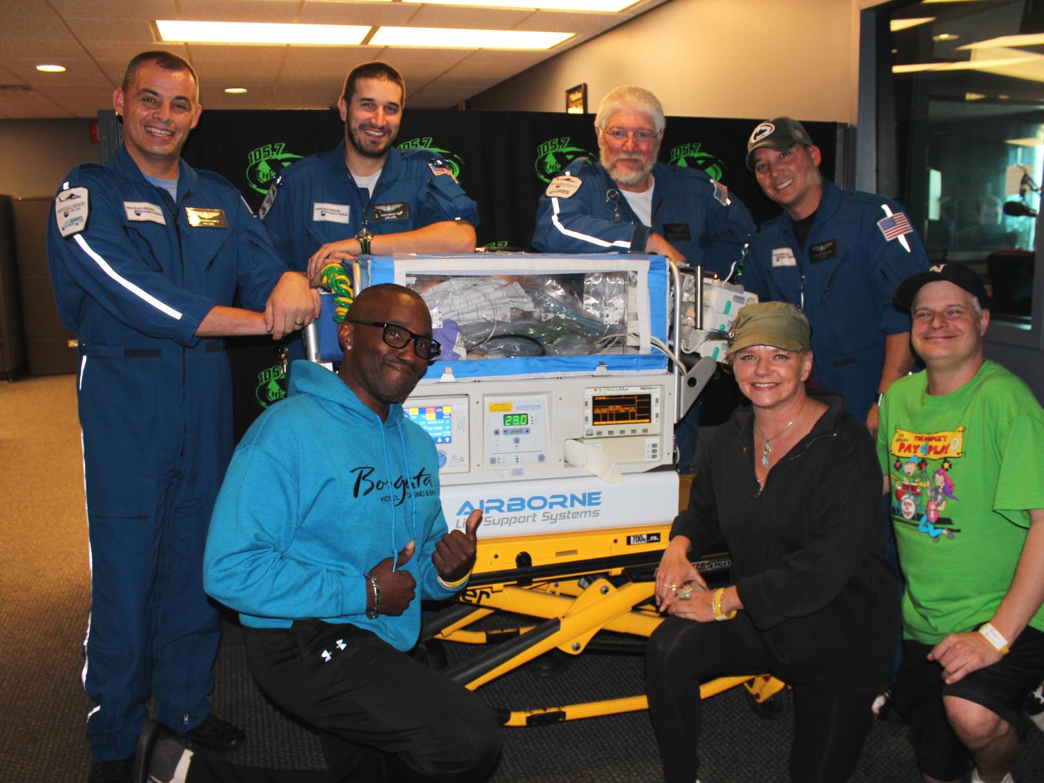 Earl David Reed, Jen Shade and Nipsey pose with members of Penn State Life Lion Critical Care Transport.