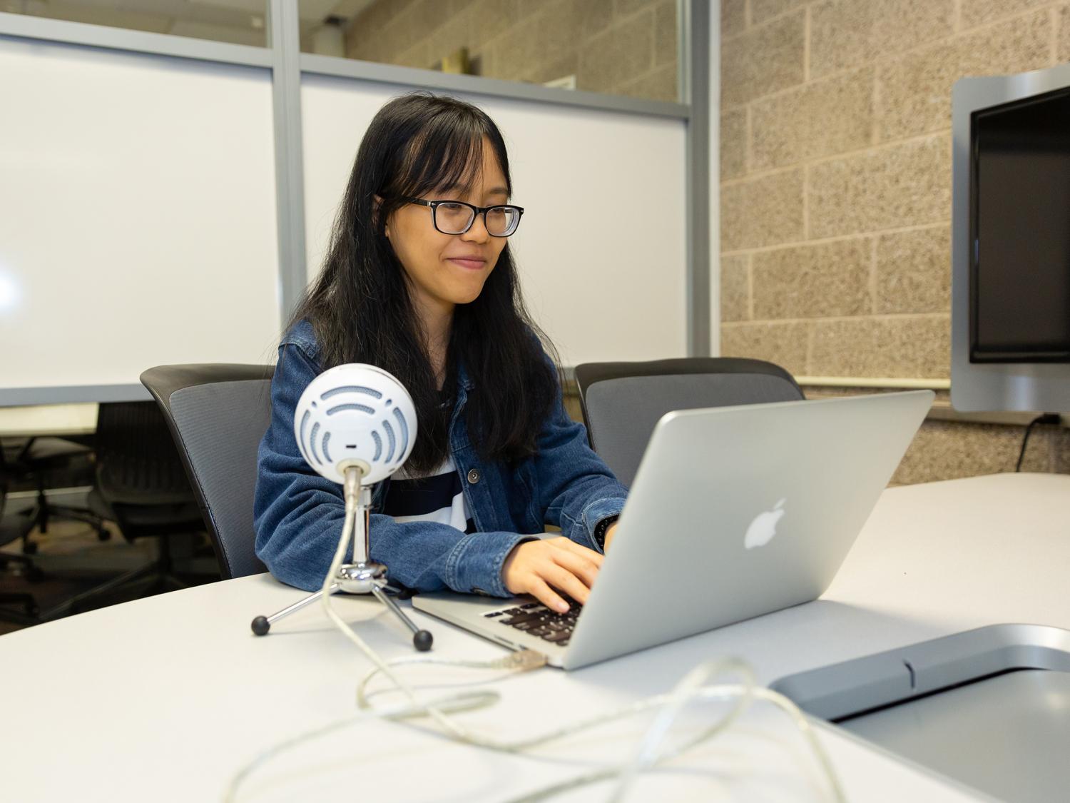 Anna Nguyen at Penn State Brandywine in front of a laptop. 