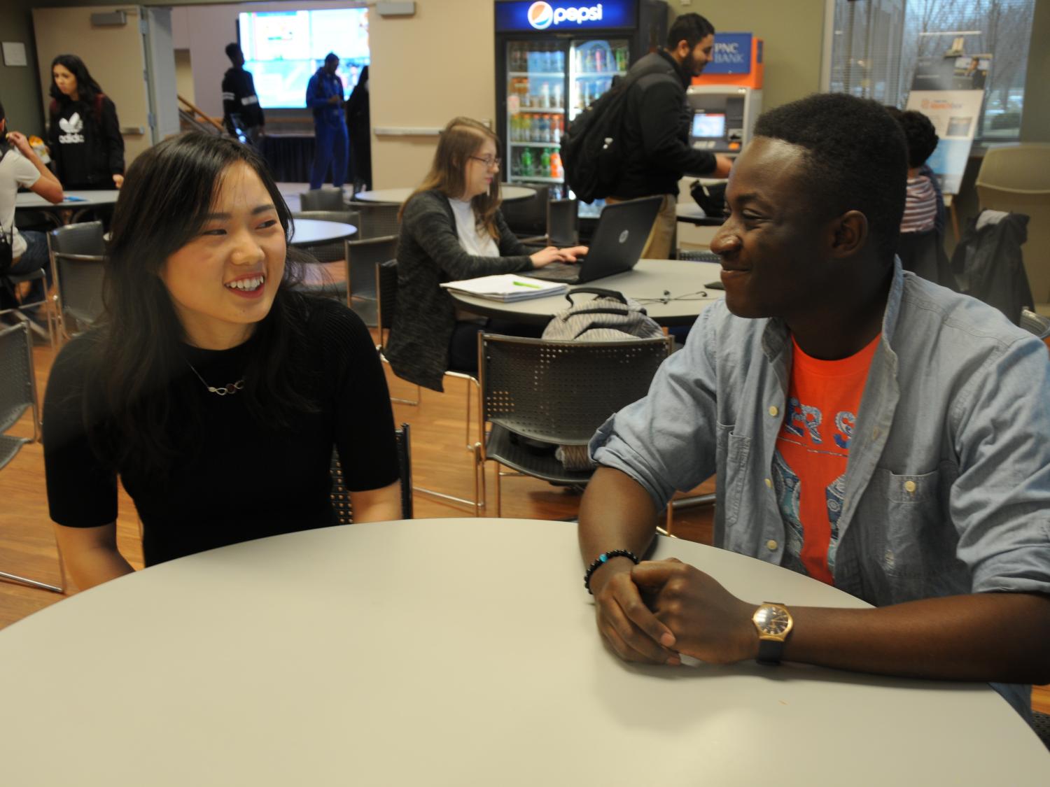 Two students sitting at a table in Lion's Den cafeteria