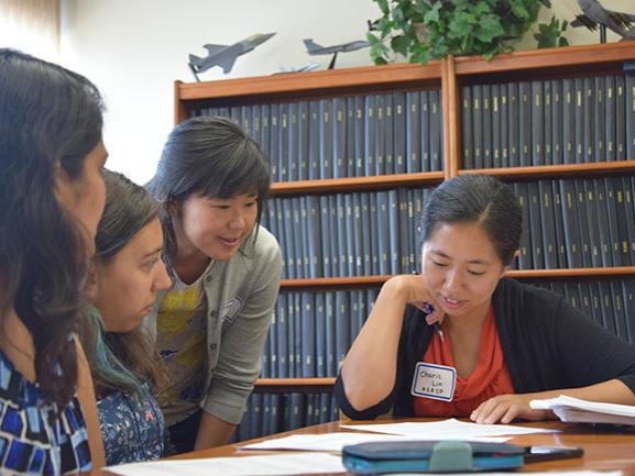 Namiko Yamamoto, assistant professor of aerospace engineering, works with female engineering graduate students during a professional skills exercise at the inaugural Graduate AeroWomen Professional Development Workshop.