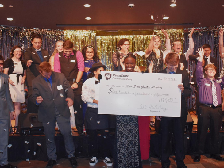 Students reveal donation total at this year’s All That’s Jazz scholarship benefit on October 14th.  
