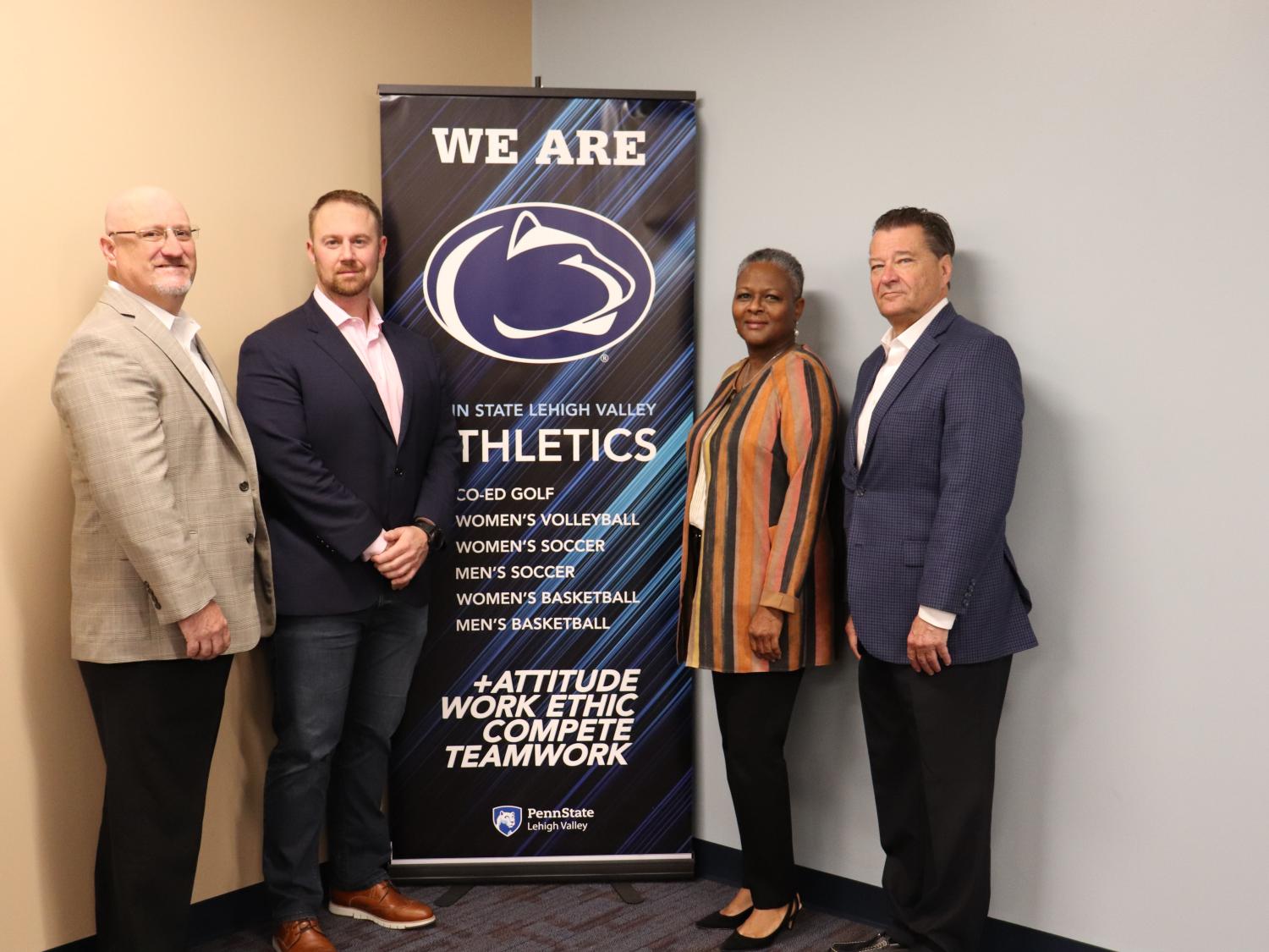 four people near athletics banner