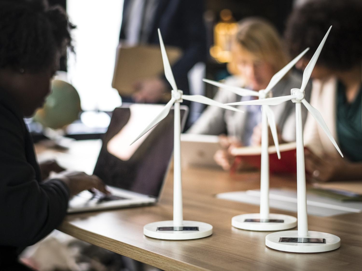 Person at laptop with windmill models