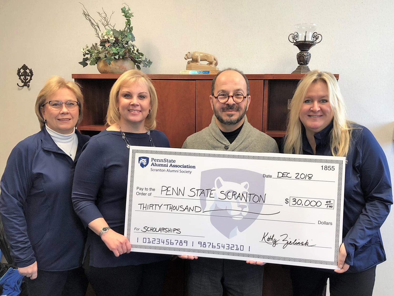 alumni officers present scholarship to chancellor