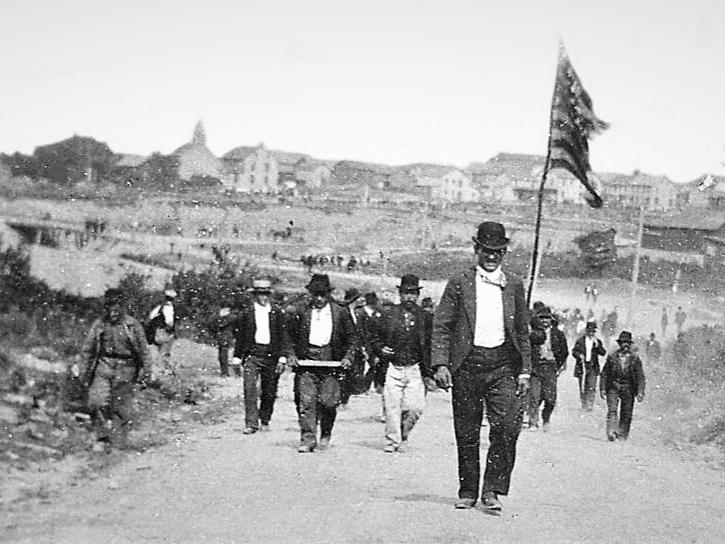 Historic photo of anthracite miners walking down street