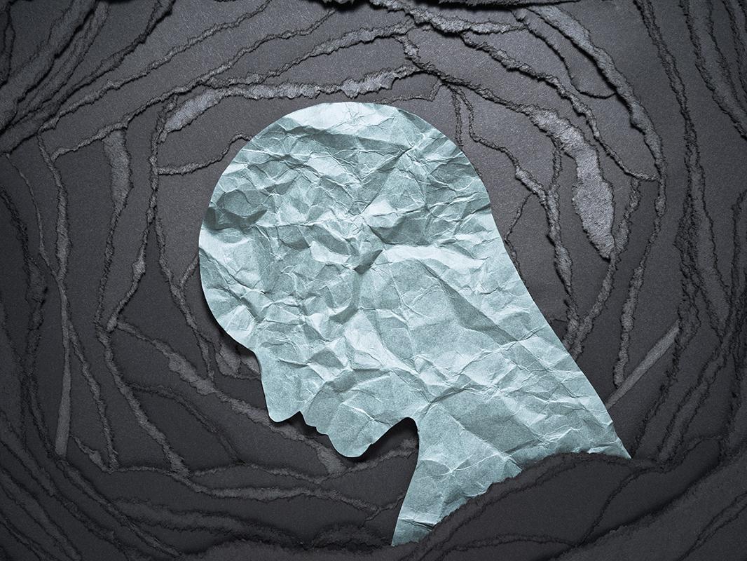 An abstract art image showing a profile of a person's head looking down