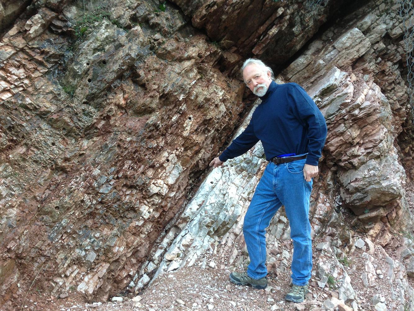 Mike Arthur at outcrop in Cretaceous/Tertiary Boundary near Gubbio, Italy.