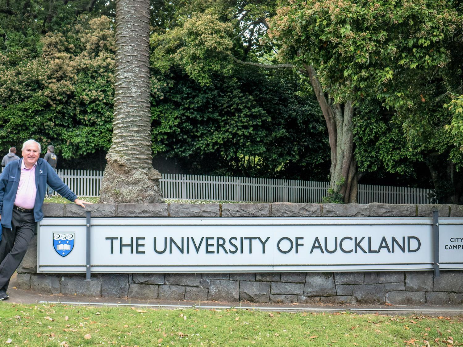 Dr. Alan Peslak at the entrance and sign to the University of Auckland