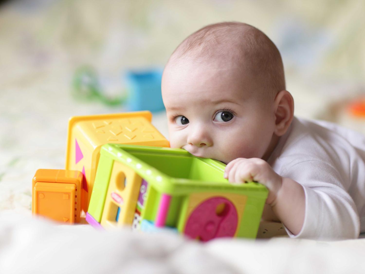 baby with toy in mouth