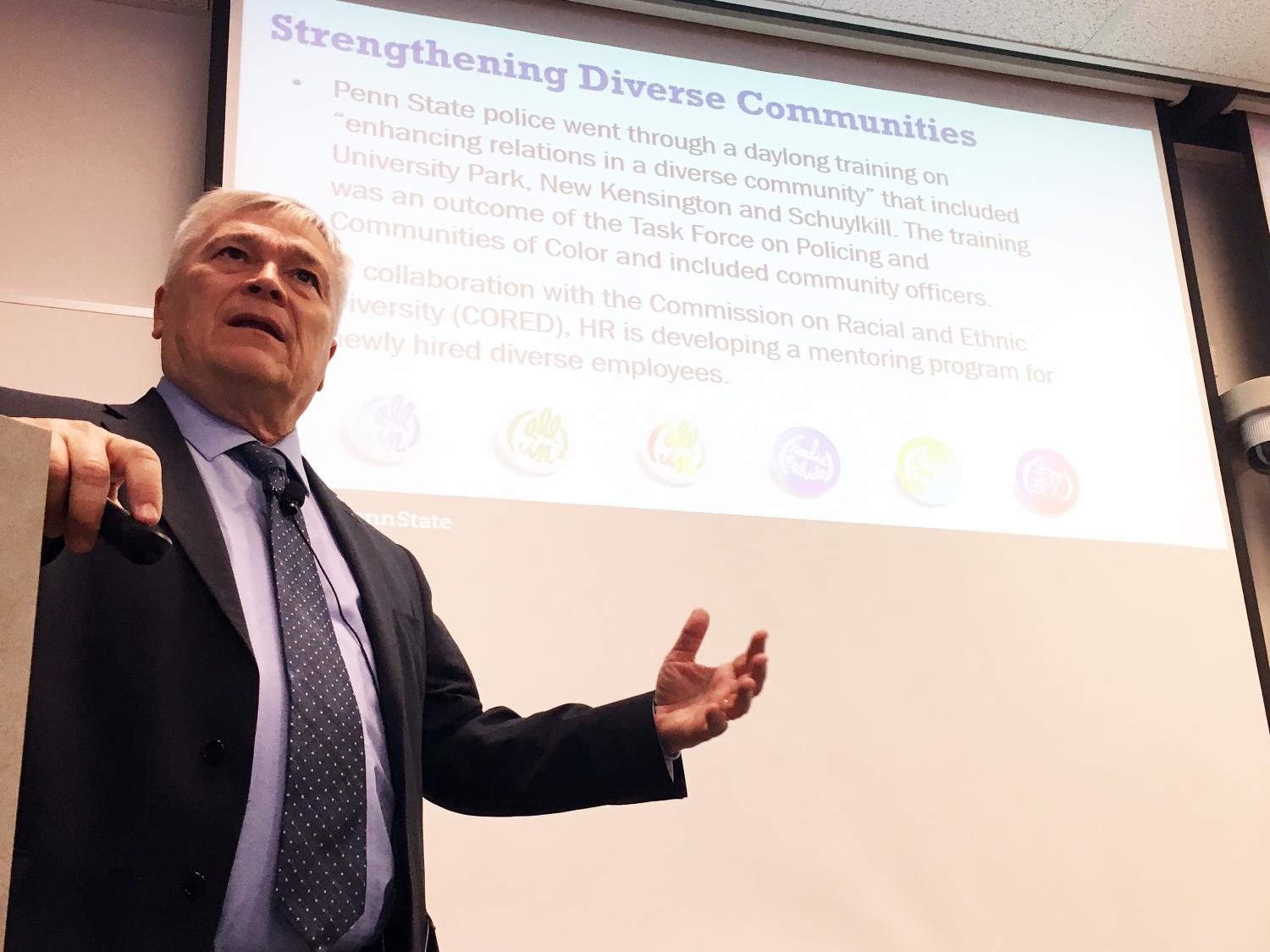 Barron speaking in front of PowerPoint presentation