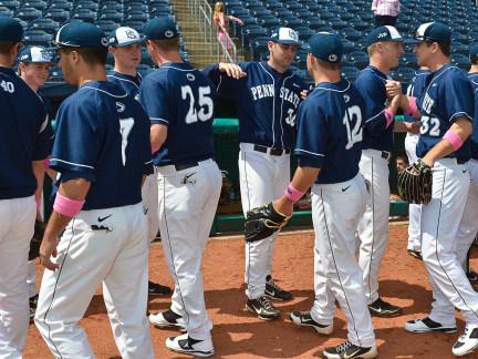 Members of the Penn State baseball team exchange handshakes and high fives