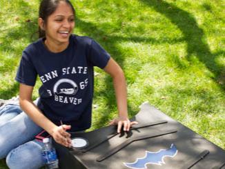 Ruhi Patel paints a bat house for the Beaver campus.