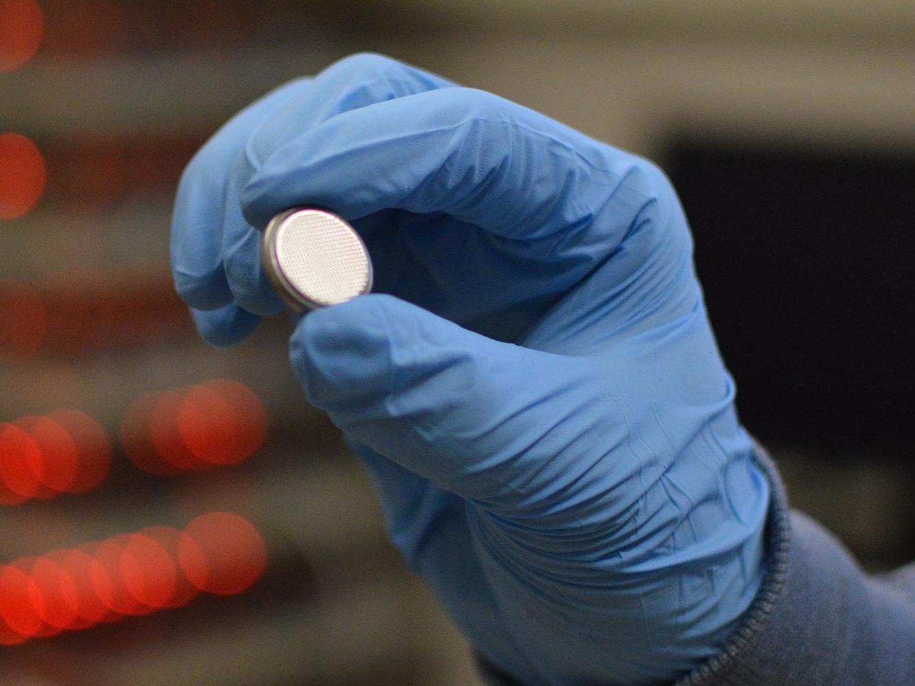 dot battery in gloved hand