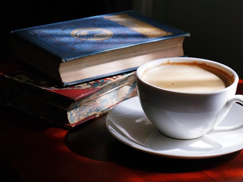 photo of old books and coffee cup