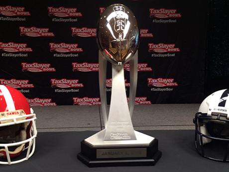 Teams' helmets flank bowl trophy