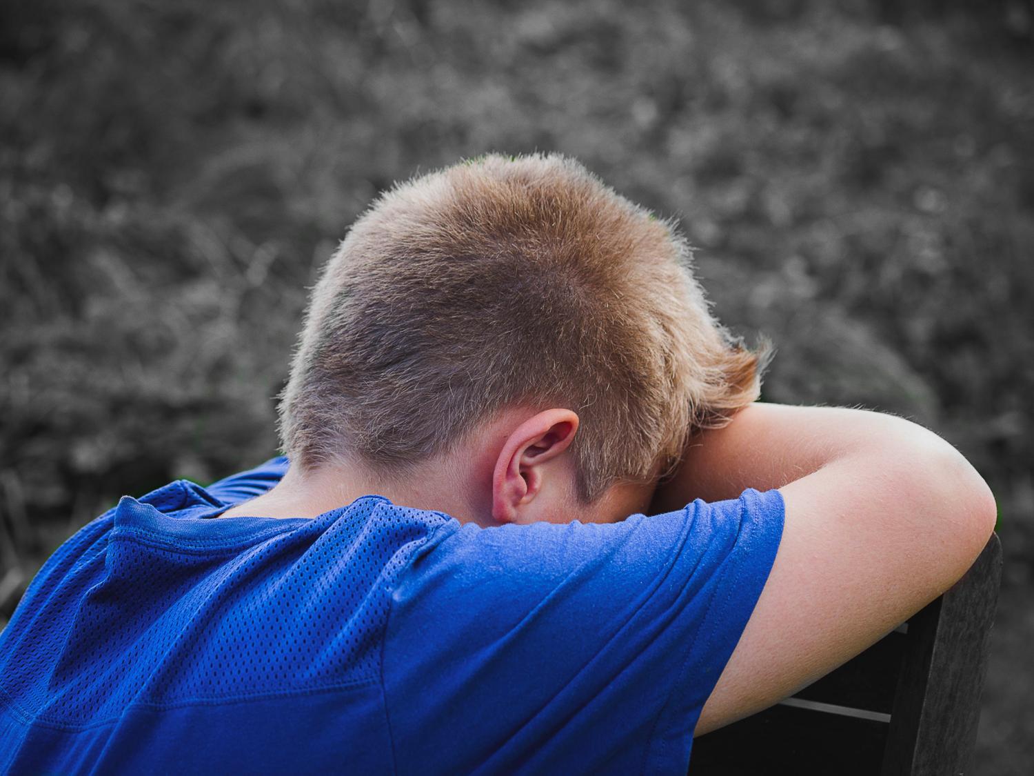 boy holding his head