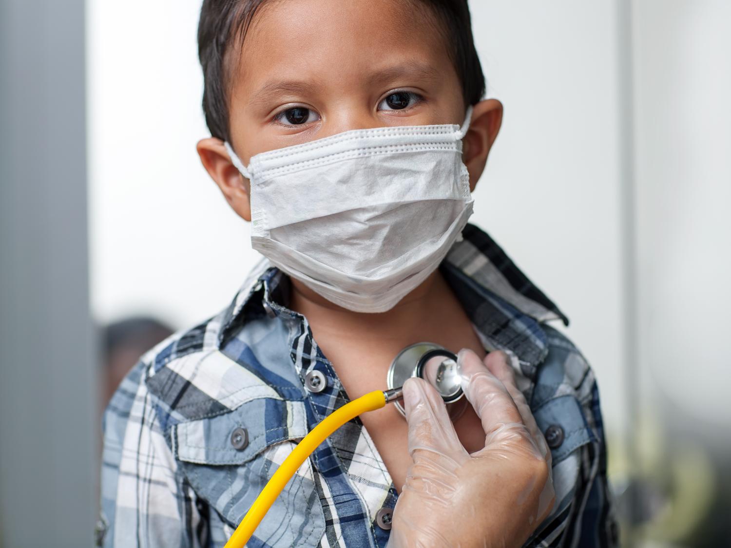 Young boy in mask with stethoscope on chest